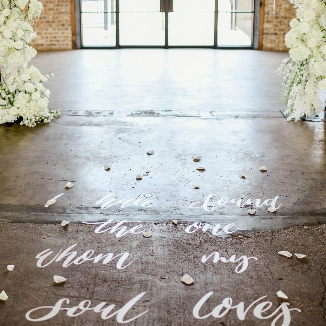 writing on the ground for a wedding aisle